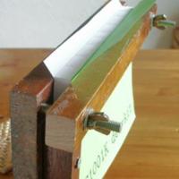 A book in clamps, ready for adhesive binding.